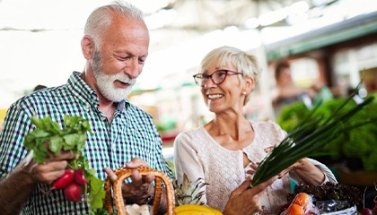 Couple buying vegetables at the farmer’s market