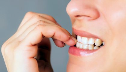 Closeup of patient biting their nails