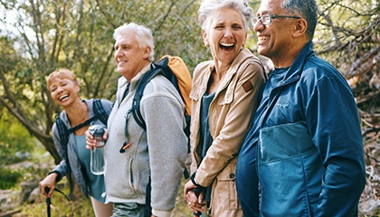 Group of adults outside hiking and laughing